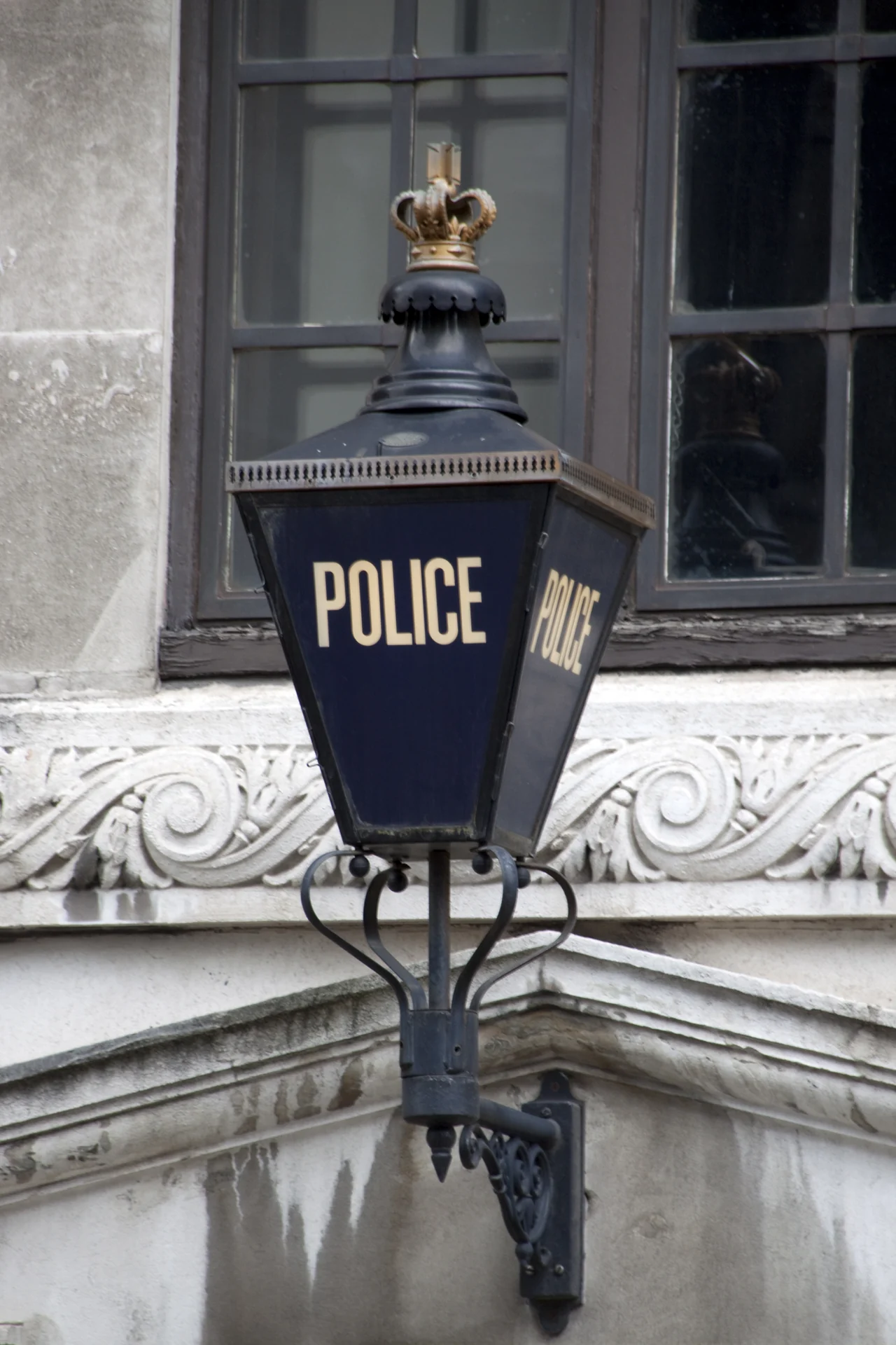 A blue lantern marked POLICE on a London building, photographed in August 2010.