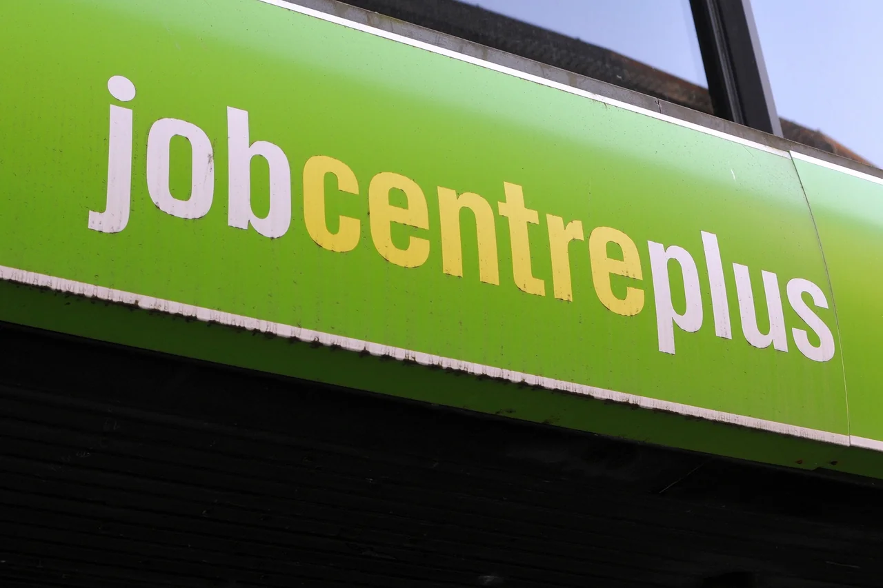 A large green Jobcentre Plus sign above a London office, photographed in October 2011, with no people visible