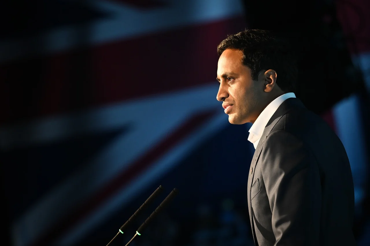 Zia Yusuf in profile at microphones in front of a blurred Union flag, speaking at the Birmingham NEC in June 2024